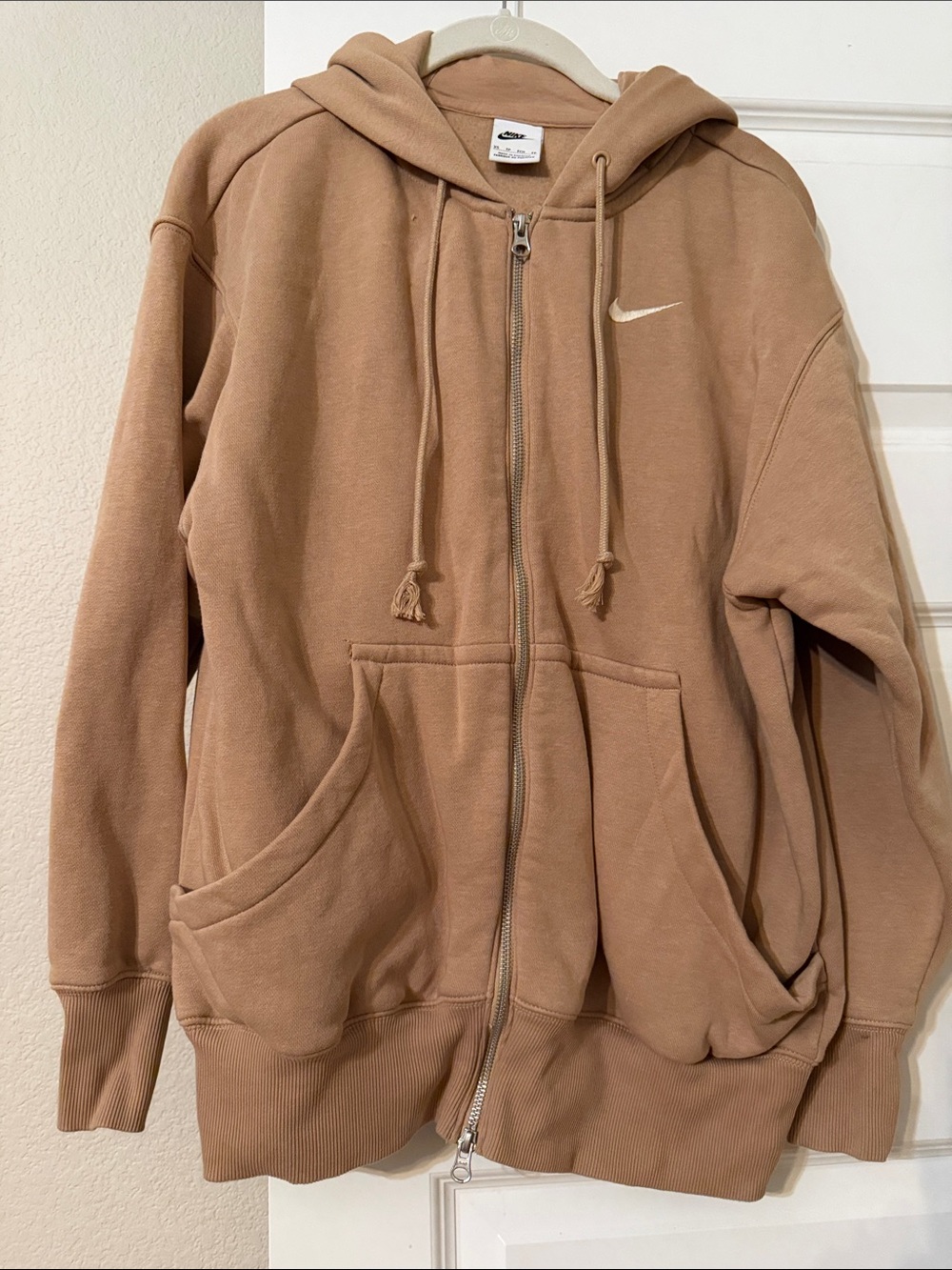 Women’s Nike zip front jacket with hood.
